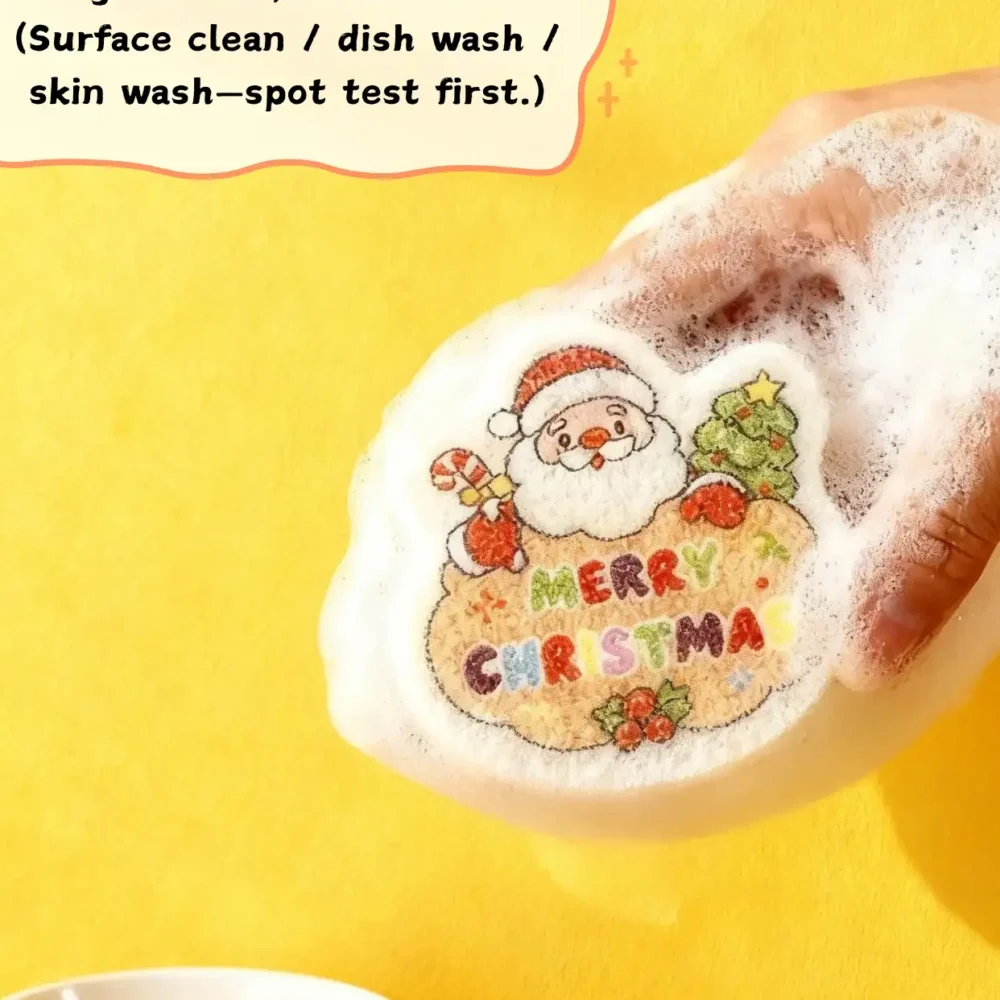 Santa Claus cellulose sponge foaming up with soap on a yellow background, held in hand while washing.