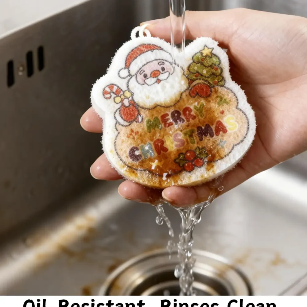 Santa Claus cellulose sponge under running water in a kitchen sink, rinsing away oil and food residue.