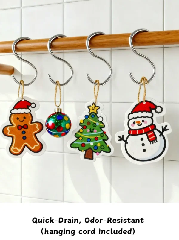 Gingerbread man, Christmas tree and snowman cellulose sponges hanging from white hooks by their cords to dry.