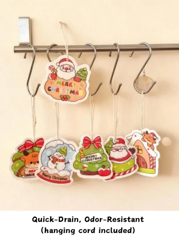 Multiple Santa Friends cellulose sponges hanging by their cords on a rail to dry, showing quick-drain storage.