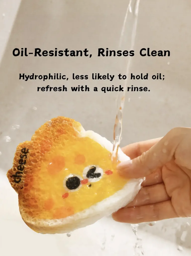 Cheese-shaped cellulose sponge rinsing clean under running water