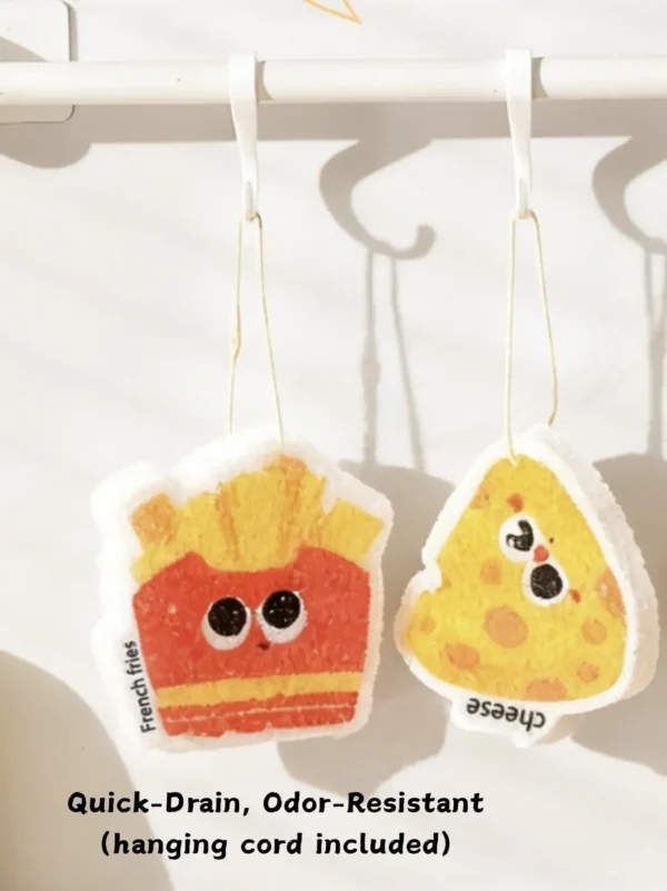 French fries and cheese cellulose sponges hanging by cords to dry