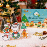 Christmas Friends cellulose sponge gift box displayed with Santa, snowman, gingerbread, wreath, stocking, and Christmas tree character sponges in a festive holiday setup.